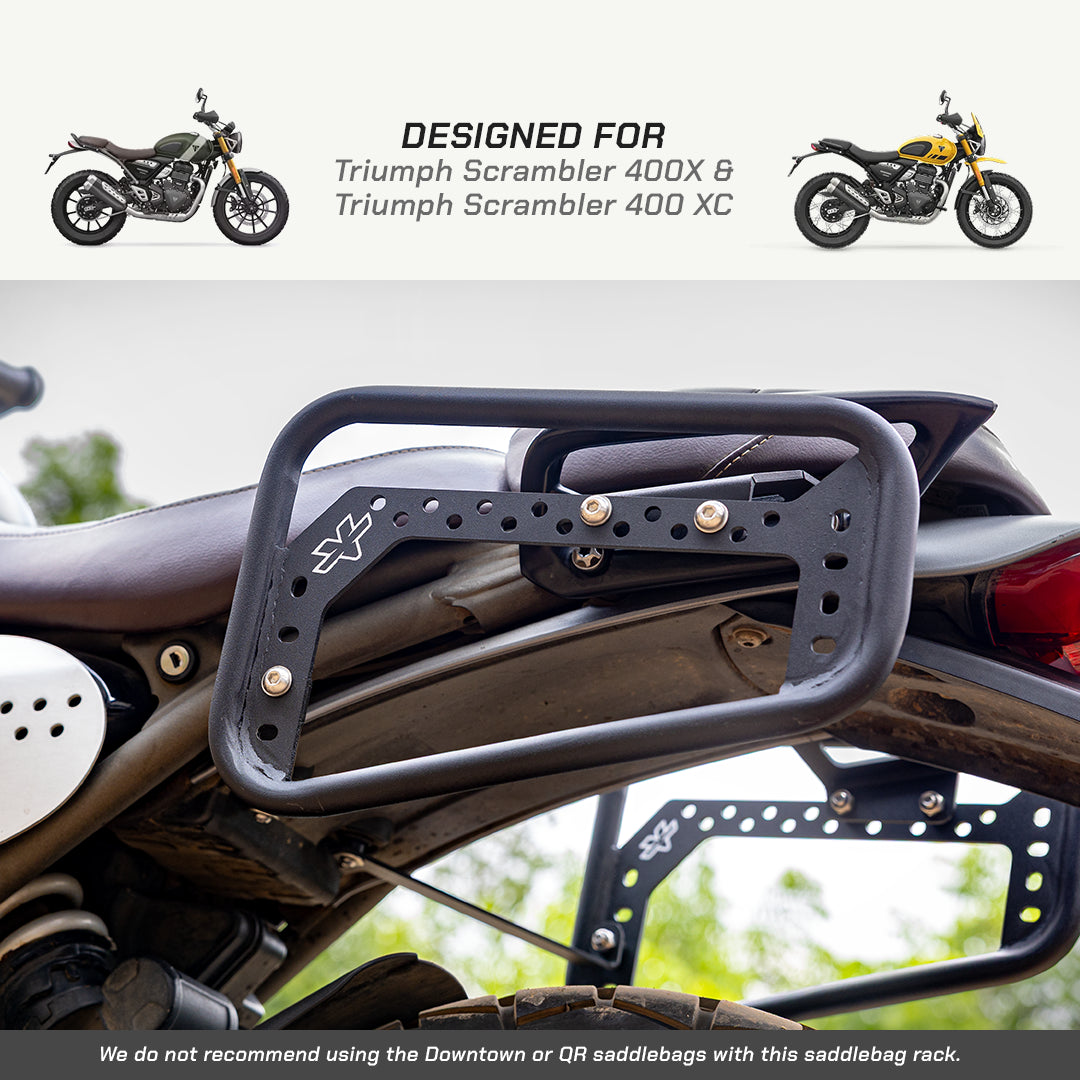 Black metal motorcycle saddlebag rack mounted on a motorcycle seat, with text at the top stating 'DESIGNED FOR Triumph Scrambler 400X & Triumph Scrambler 400 XC' and small motorcycle photos on either side.