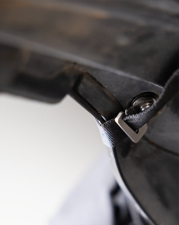Optional Rear Mounting Close-up of a black leather bag with a silver buckle on a blurred background