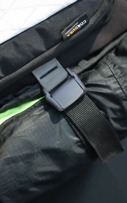Cam-Lock Adjustment Close-up of a black strap with a buckle on a product, featuring the 'Cornille' brand label.