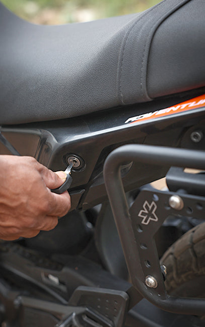 Configured so it does not obstruct everyday usage Person unlocking a motorcycle with a key