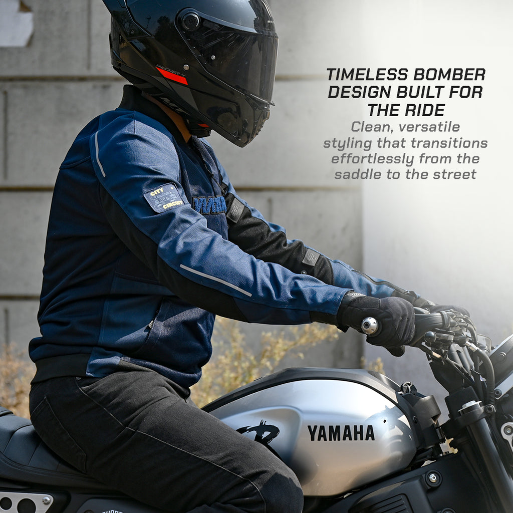 color_common Person on a Yamaha motorcycle wearing a blue jacket and black helmet, with text about the jacket's design.