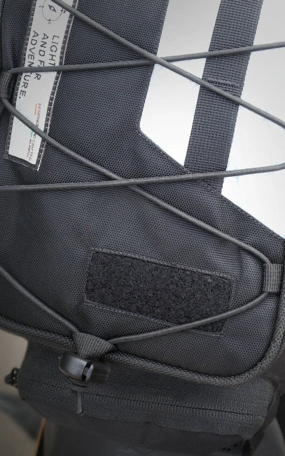 Custom Patch Panel Close-up of a black tactical backpack with straps and a visible brand label.