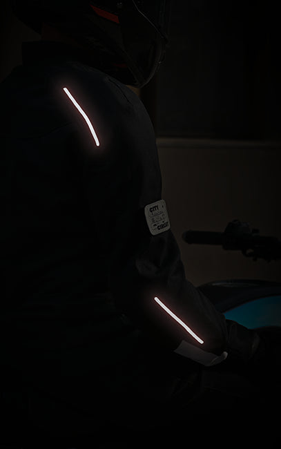 Person wearing reflective safety gear in a dark setting