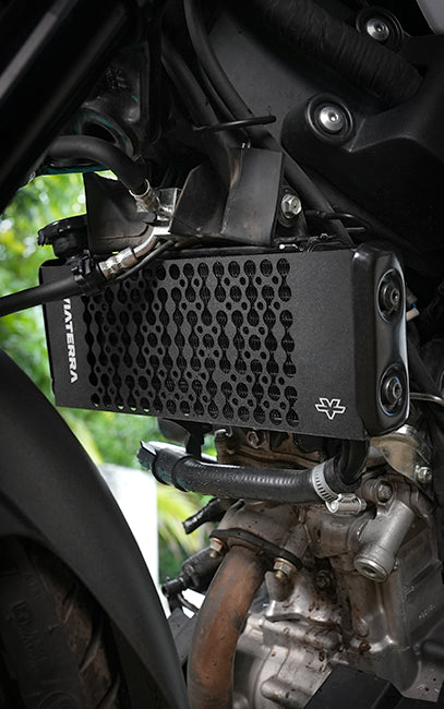 Extended coverage A close-up of a black Lattiera motorcycle engine filter mounted on a motorcycle engine, with the brand name 'LATTIERA' printed vertically on the front grille.