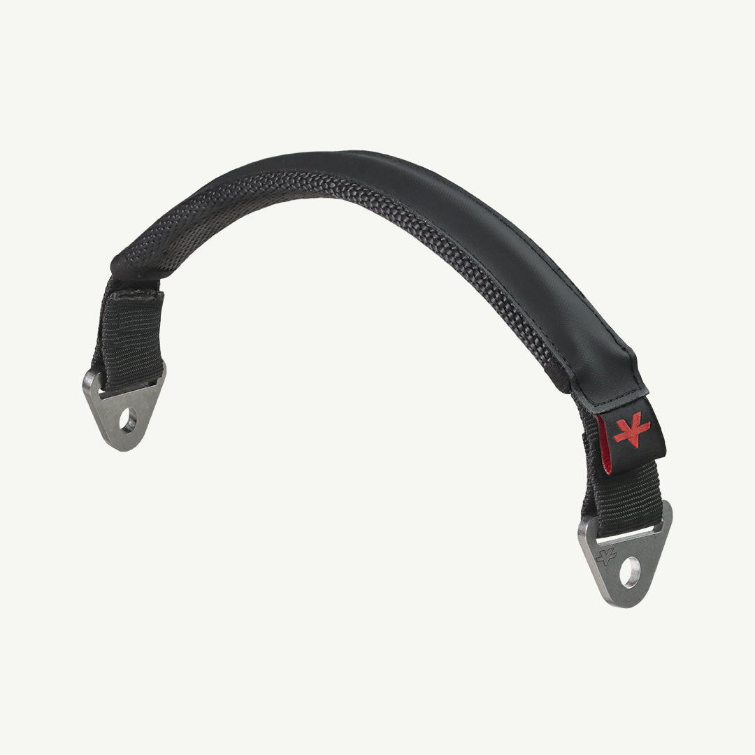 color_black A black padded handlebar grip with silver metal mounting brackets and a small red logo, shown against a plain off-white background.