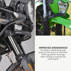 color_black A black Discovery motorcycle handlebar grabber shown installed on a bike, with a close-up of the green front fender and handlebar area demonstrating its use. Text on the right reads 'IMPROVED ERGONOMICS' and describes the grip point for lifting or pulling the motorcycle.