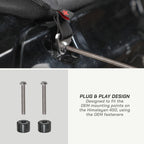 color_black Close-up of a motorcycle seat strap being adjusted with a screwdriver, with two metal mounting bolts and two black rubber pads shown below, plus text reading 'PLUG & PLAY DESIGN' and 'Designed to fit the OEM mounting points on the Himalayan 450, using the OEM fasteners'.