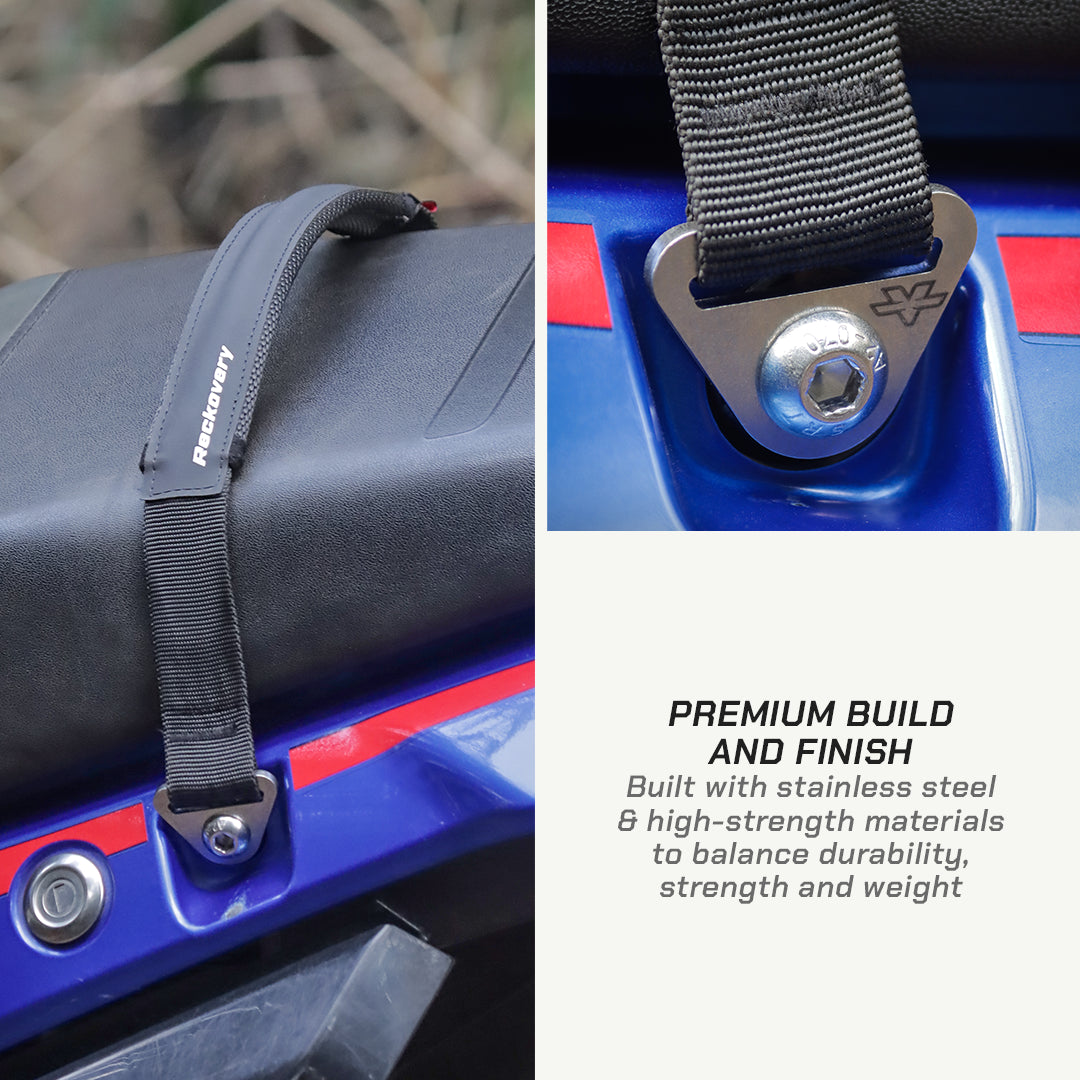 color_black A black Recovery motorcycle seat belt strap shown attached to a blue motorcycle, with a close-up of the metal buckle and text reading 'PREMIUM BUILD AND FINISH'.