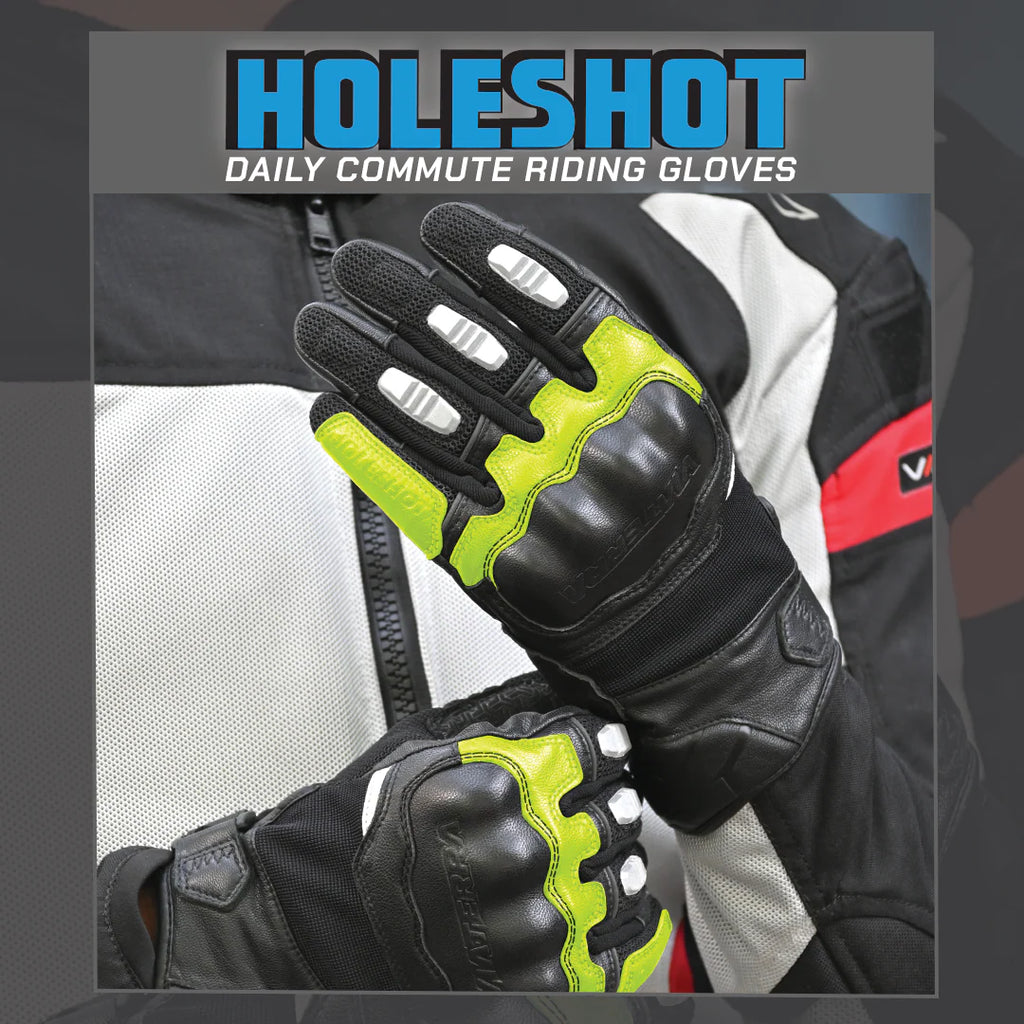 color_common Black riding gloves with green accents on a blurred background, featuring the brand 'Holeshot'.