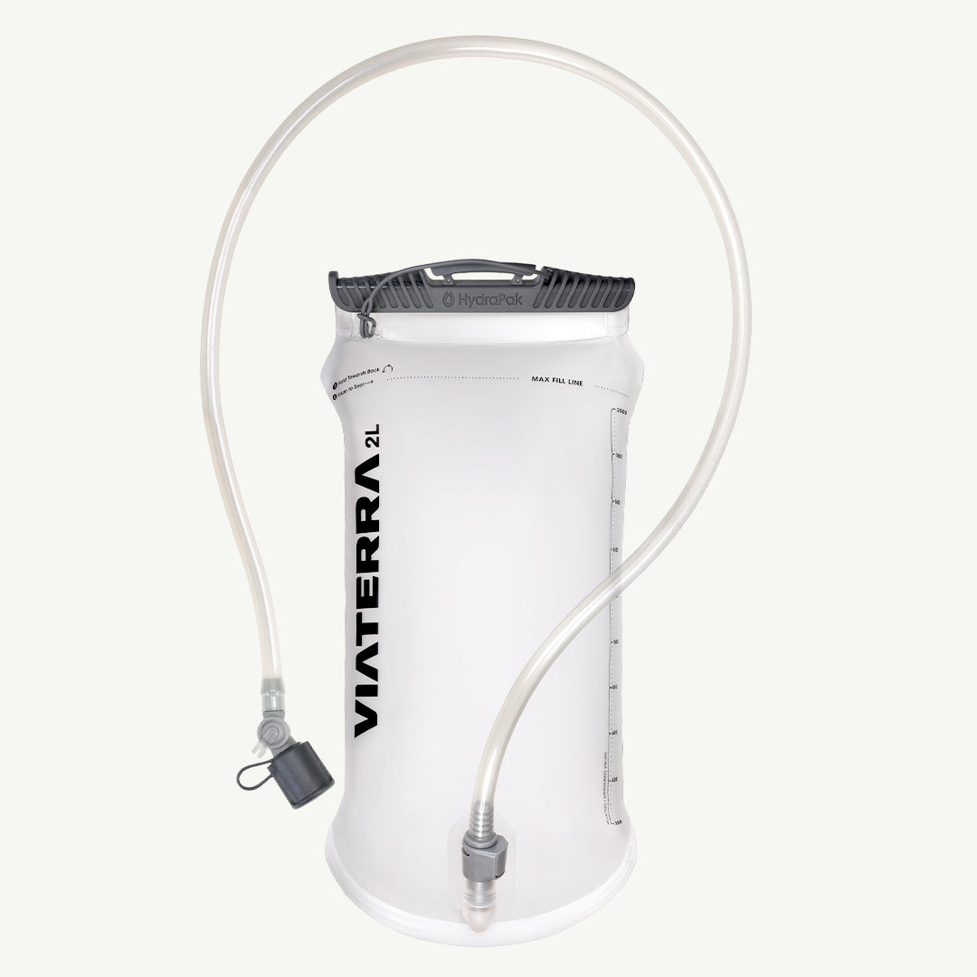 VIATERRA HYDRAPAK ELITE 2L BLADDER  A 2-liter Viaterra water bladder in white with a black top cap and clear drinking tube, shown against a light off-white background.