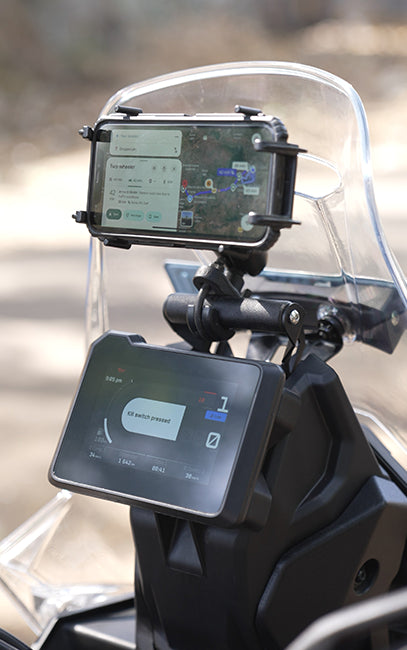 Improved ergonomics Phone mounted on a motorcycle dashboard with a clear windshield