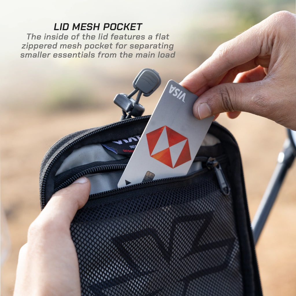 LFA - Tank Bag - XC Person opening a black mesh pocket with a card inside, featuring text about the lid mesh pocket.