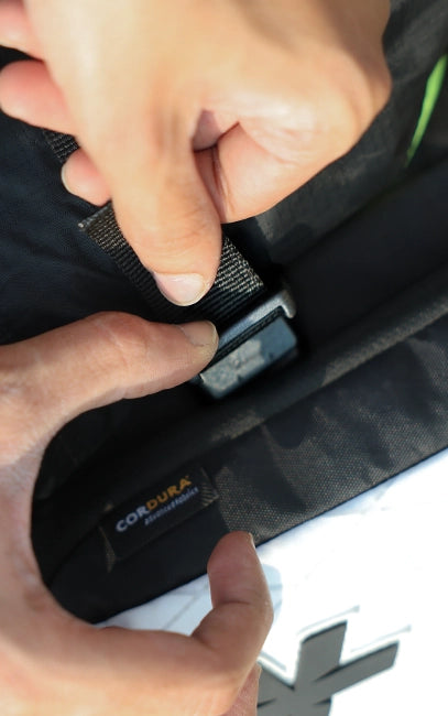 Multi-Point Compression Person fastening a car seat belt with a close-up of the buckle, featuring the 'Cobra' brand.