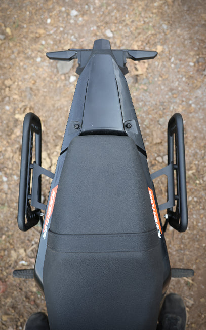 Precision & Consistency Top view of a black motorcycle seat with visible branding on a textured surface