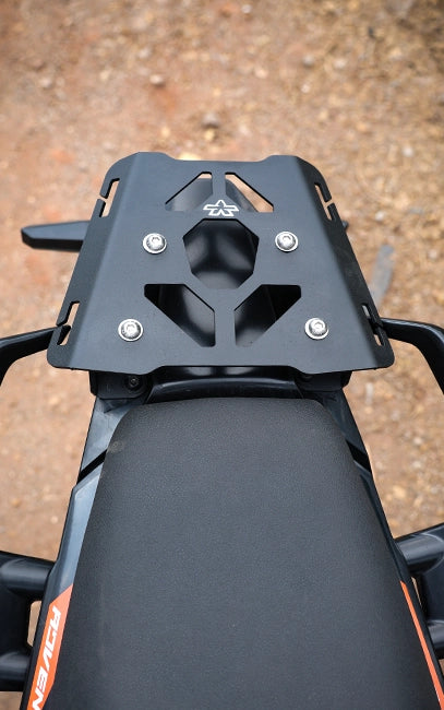 Precision & Consistency Motorcycle seat with a black luggage rack on a textured brown surface