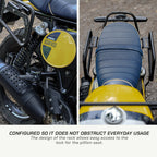 Saddlebag Rack - Royal Enfield BEAR 650 Close-up of a motorcycle seat and handlebar with text about easy access to the lock for the pillion seat.