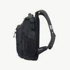 A black tactical sling backpack shown from a side profile view against a light off-white background. The backpack features multiple zippered compartments, a padded shoulder strap, and a visible 'SKYFIT' brand logo on the strap.