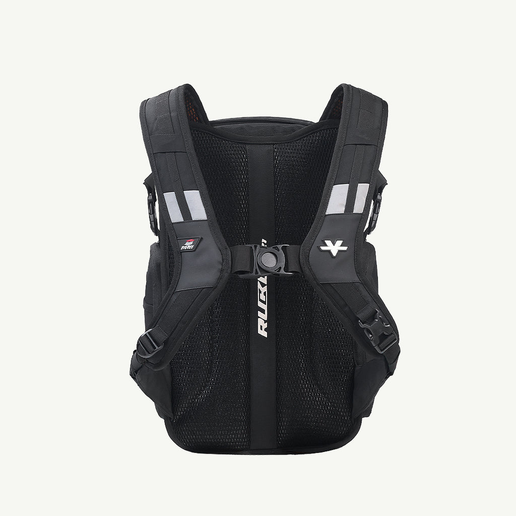 A black Ruxa cycling backpack shown from the back, featuring a breathable mesh back panel, padded shoulder straps, reflective white stripes, and a central vertical strap with the RUXA logo.