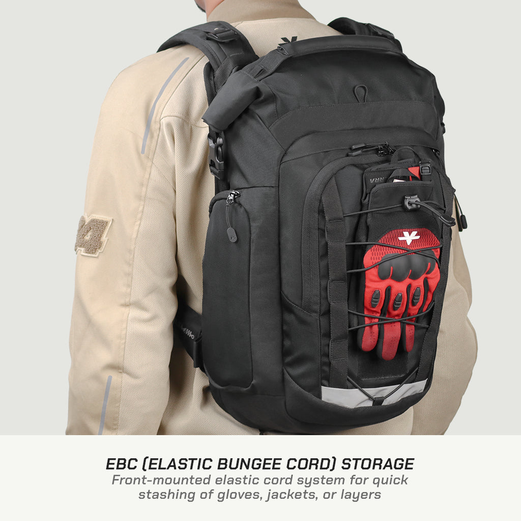 A black backpack shown on a model from the back, featuring a front pocket with an elastic bungee cord holding a red and black glove. The model is wearing a beige jacket against a light gray background, with text at the bottom explaining the EBC storage feature.