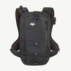 A black hydration backpack with orange mesh lining and a white stylized logo on the front, shown against a light off-white background.