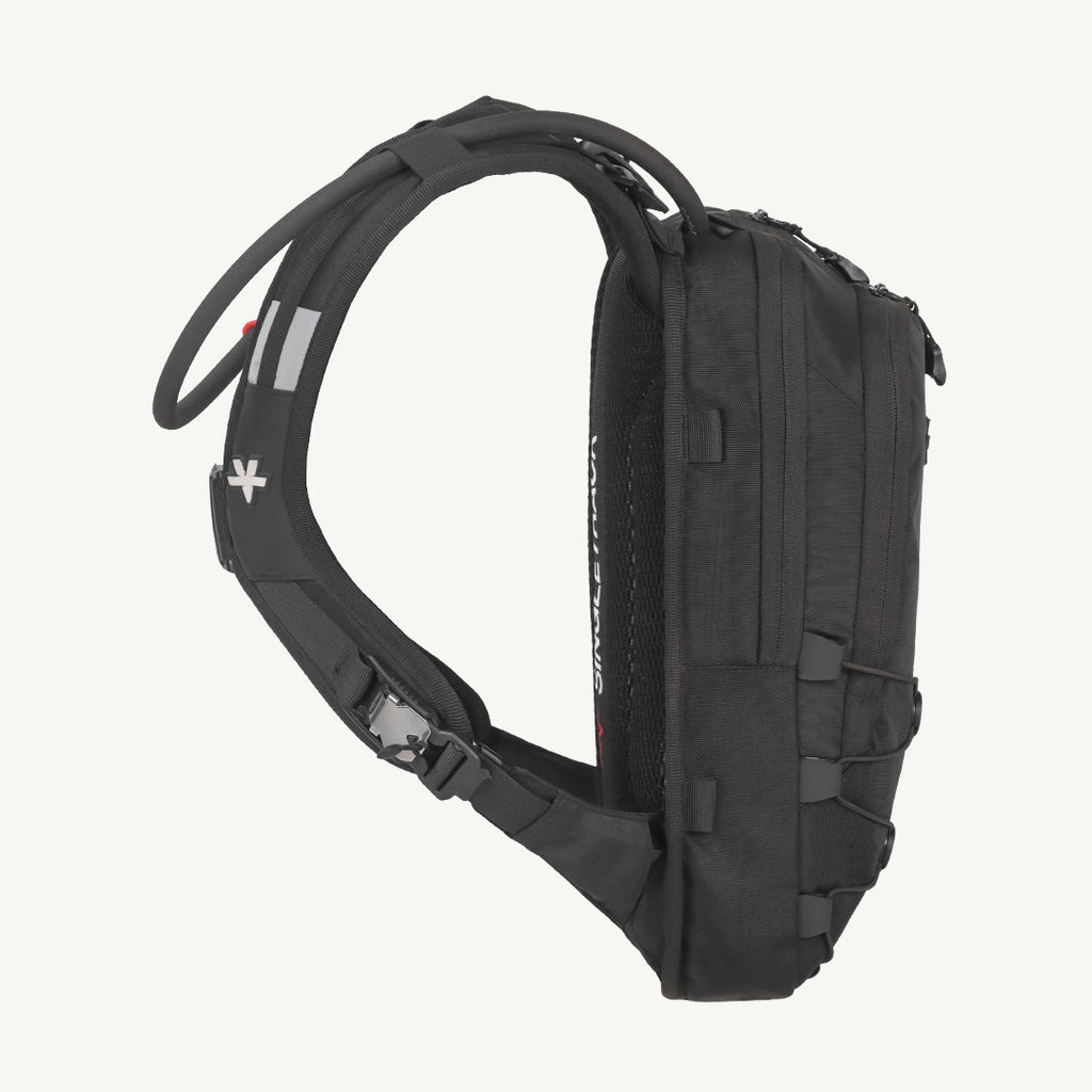 A black technical running backpack shown from a side profile view against a solid off-white background. The backpack features a padded shoulder strap, compression buckles, and multiple zippered compartments.