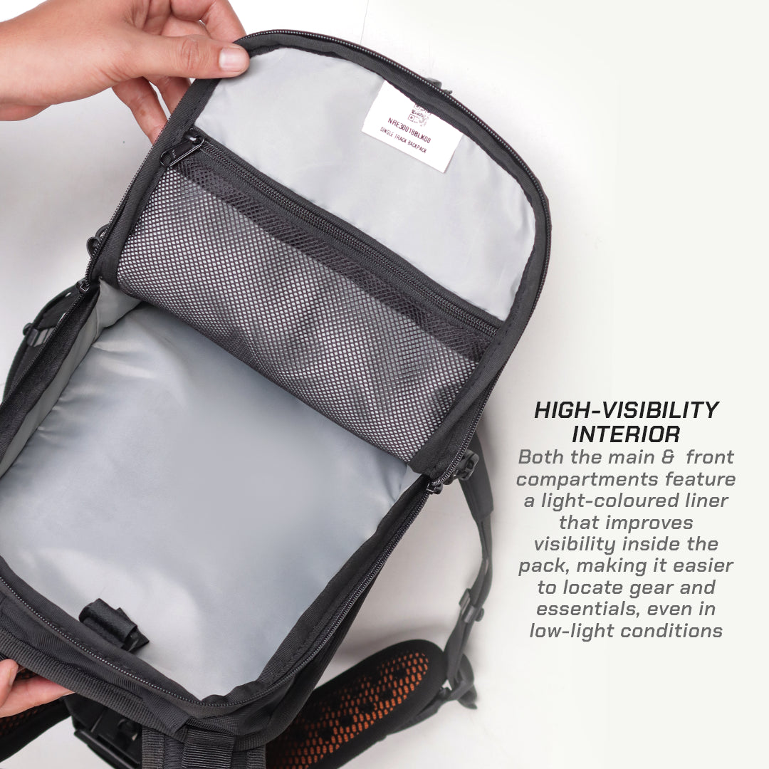 An open black and gray backpack shown from the inside, with a hand holding the top edge. The interior features a light gray lining and a gray mesh pocket.