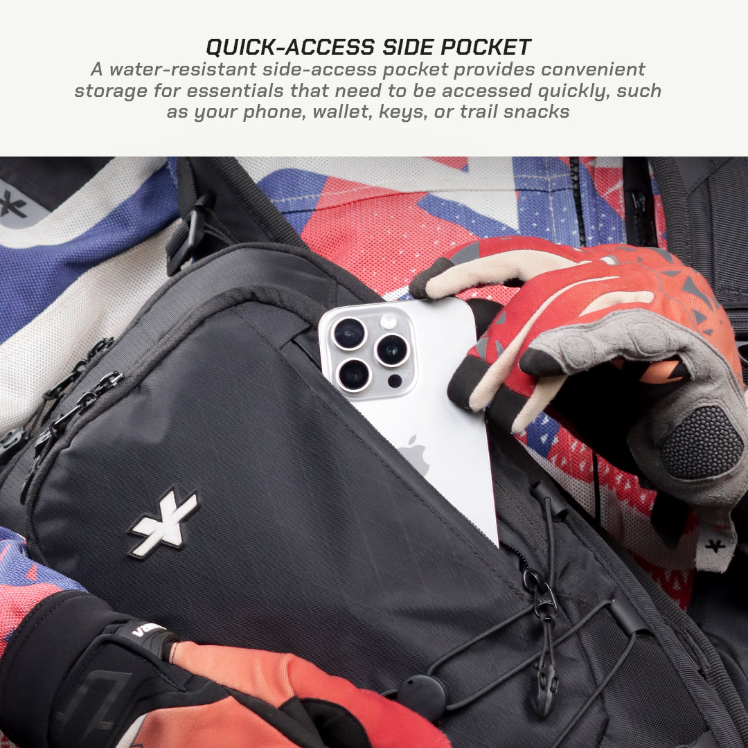 Close-up of a black crossbody bag with a quick-access side pocket, shown with a phone inserted and a person wearing red and gray gloves reaching in. Text at the top reads 'QUICK-ACCESS SIDE POCKET' with a description of its use.
