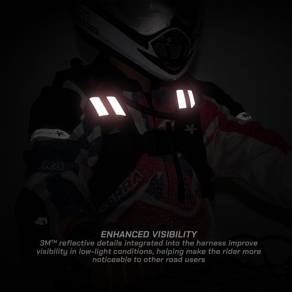 A rider in a helmet and reflective harness with bright white reflective strips on a dark background. Text at the bottom reads 'ENHANCED VISIBILITY' and '3M reflective details integrated into the harness improve visibility in low-light conditions, helping make the rider more noticeable to other road users.