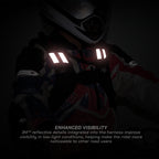 A rider in a helmet and reflective harness with bright white reflective strips on a dark background. Text at the bottom reads 'ENHANCED VISIBILITY' and '3M reflective details integrated into the harness improve visibility in low-light conditions, helping make the rider more noticeable to other road users.