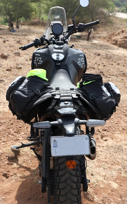 Structured Rackless Design Motorcycle with saddlebags on a dirt road