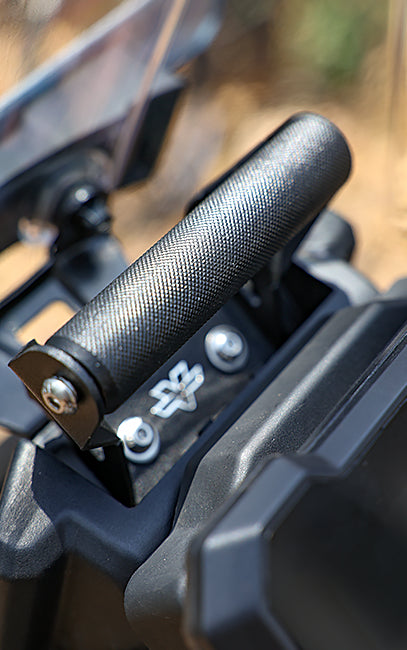 Superior grip Close-up of a black handlebar grip on a vehicle with a blurred natural background