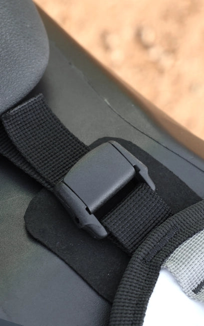 Surface Protection Interface Close-up of a black car seat belt buckle on a car seat.